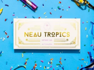 Colorful Neau Tropics THC-infused gummies in a clear container with tropical-themed packaging.