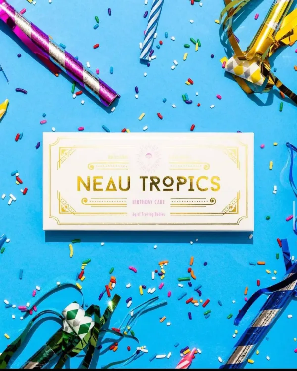 Colorful Neau Tropics THC-infused gummies in a clear container with tropical-themed packaging.